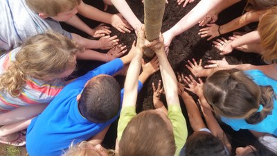 Children in Terre Haute plant a tree.